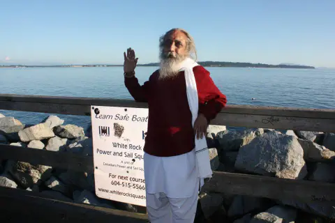 Nepali Baba standing beside the waterfront during his Canada visit