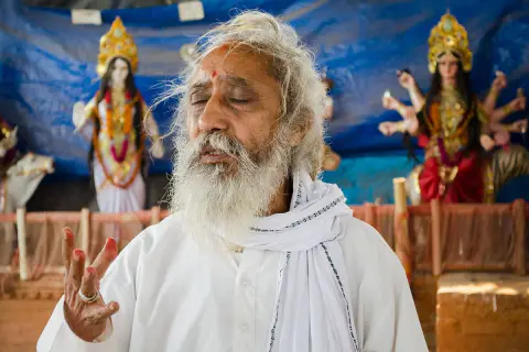 Nepali Baba speaking with a hand raised in spiritual guidance