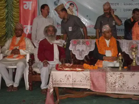 Nepali Baba seated with guests at a formal community event