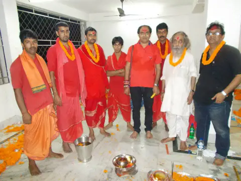 Nepali Baba standing with a group of devotees after a ceremony