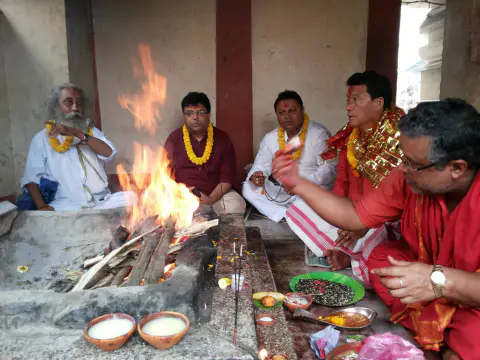 Worshippers making offerings during a Vedic fire ceremony
