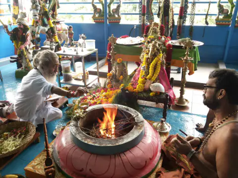 Nepali Baba participating in a Vedic ceremony beside a sacred fire